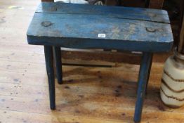 Blue painted primitive four legged stool, 59cm high by 65cm wide by 29.5cm deep.