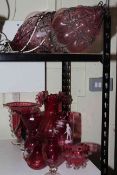 Collection of eight cranberry glass pieces including vases, and blown glass and metal lanterns.