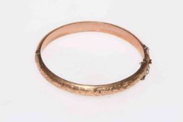 9 carat gold bangle with engraved decoration.