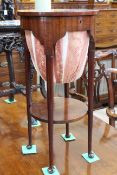 Circular mahogany sewing table on pad feet, 69cm high by 34cm diameter.
