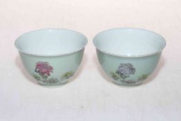 Pair Chinese tea bowls decorated with flowers and calligraphy.