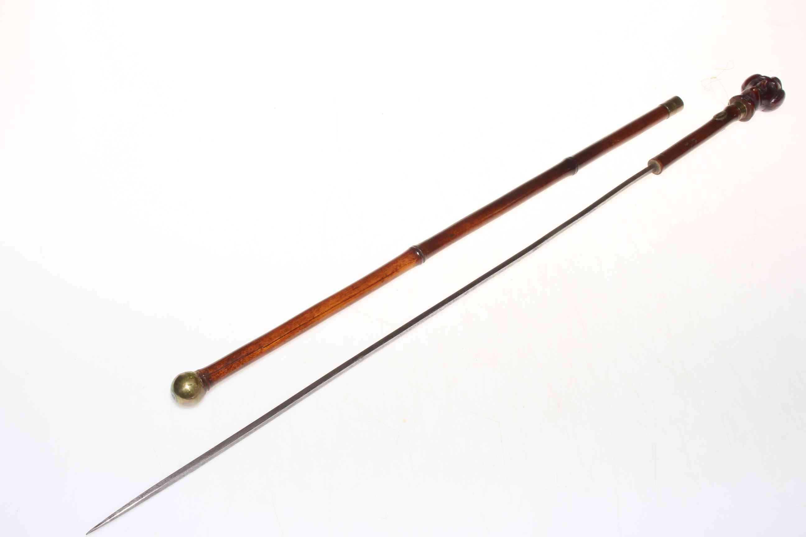 19th Century bamboo sword batten with carved male caricature top, 62cm long.
