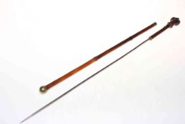 19th Century bamboo sword batten with carved male caricature top, 62cm long.