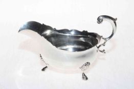Barnard's silver sauce boat with scroll handle and hoof feet, London 1909.
