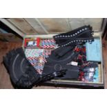 Vintage tin trunk containing Scalextric accessories.