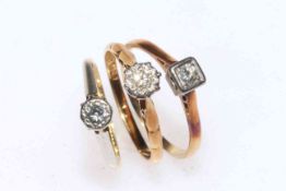 Three 18 carat gold and single stone diamond rings.