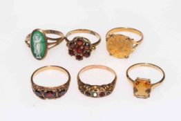 Collection of six 9 carat gold rings including 1858 one dollar, garnets, etc.