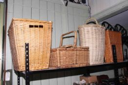 Four wicker baskets including hamper and laundry.