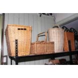 Four wicker baskets including hamper and laundry.