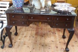 Late 19th/early 20th Century mahogany five drawer writing desk on carved cabriole legs to hirsute