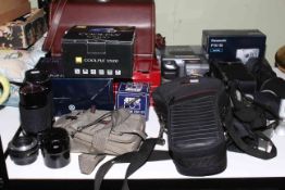 Collection of cameras, lenses and cases including Panasonic.