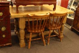 Rectangular pine dining table and four spindle back chairs.
