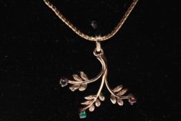 9 carat gold pendant and chain, the leaf form with tiny emerald, sapphire and ruby.