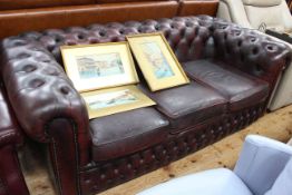 Ox blood buttoned leather three seater Chesterfield settee.