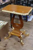 Gilt painted lyre pedestal occasional table on four scrolled legs,