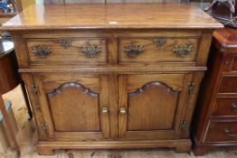 Good quality period style oak dresser having two drawers above two arched fielded panel doors, 91.