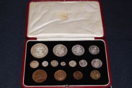 A good George V 1937 specimen coin set within a burgundy red gilt presentation leather case.