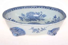 Antique Chinese blue and white oval dish having flower sprays and on natural feet, 32cm across.