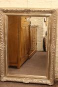 Silvered framed bevelled wall mirror, 115cm by 85cm overall.