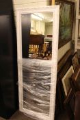 Rectangular white framed wall mirror, 153cm by 59cm overall.