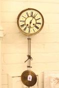 Victorian circular brass wall clock with enamelled dial.