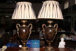 Pair of vase shaped table lamps and shades with serpent handles, 88cm high.