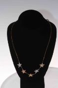 14 carat two colour gold and diamond set star necklace on 9 carat gold chain.