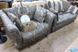 Three seater settee and chair in classical patterned fabric.
