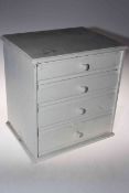 Four drawer cabinet housing collectables including commemorative medals, coins, compacts, toys,