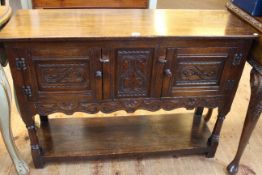 Carved oak two door potboard side cabinet, 76cm high by 104cm wide by 33cm deep.