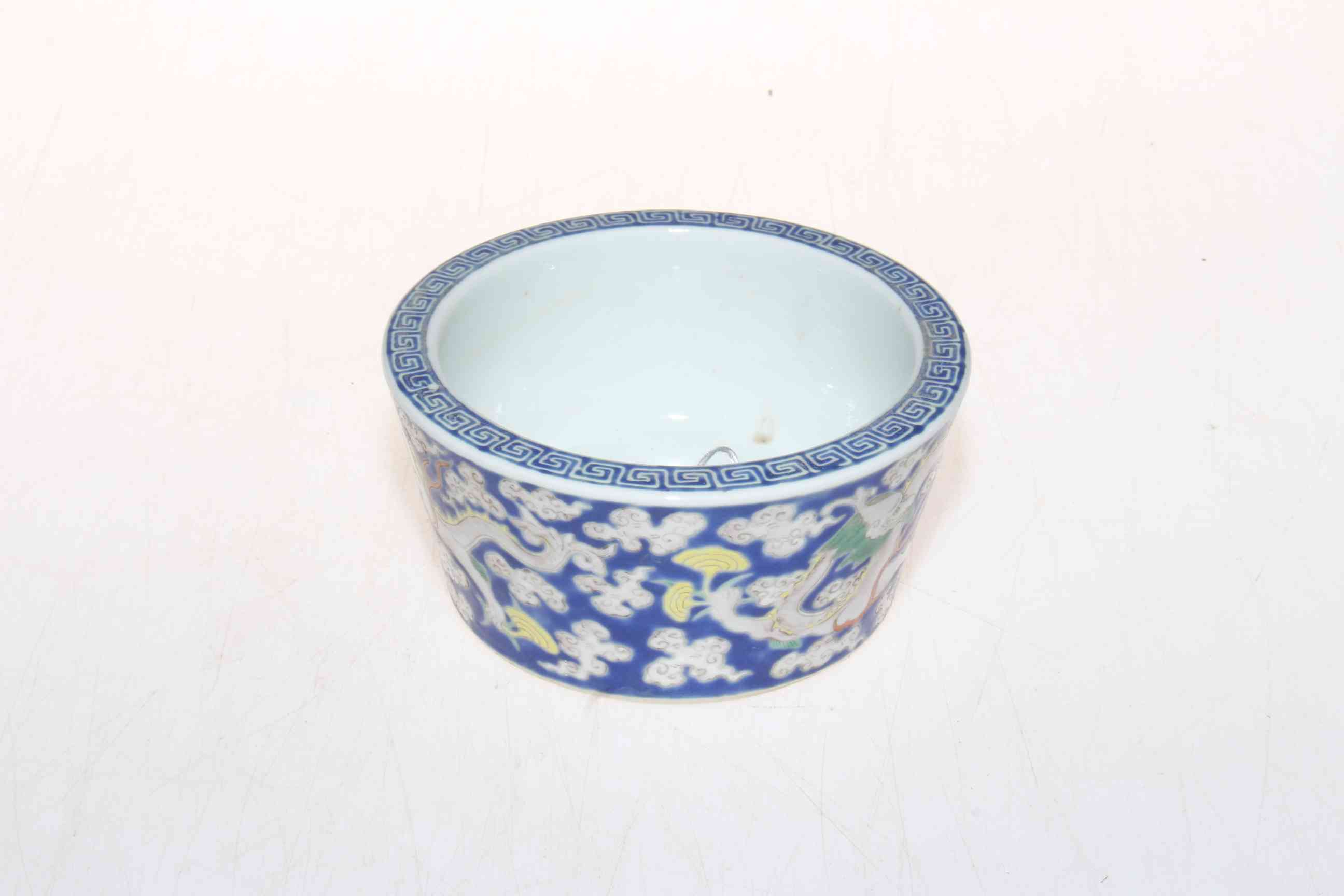 Chinese brush pot with trailing dragon decoration and Grecian key border, 11cm diameter.