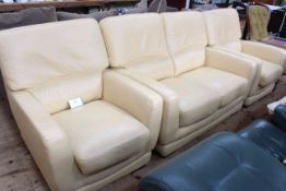 Cream leather three piece lounge suite comprising two seater settee and two chairs.