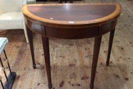 Mahogany and satinwood demi lune fold top tea table on square tapering legs to spade feet,