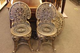Gilt coloured circular patio table and two chairs.