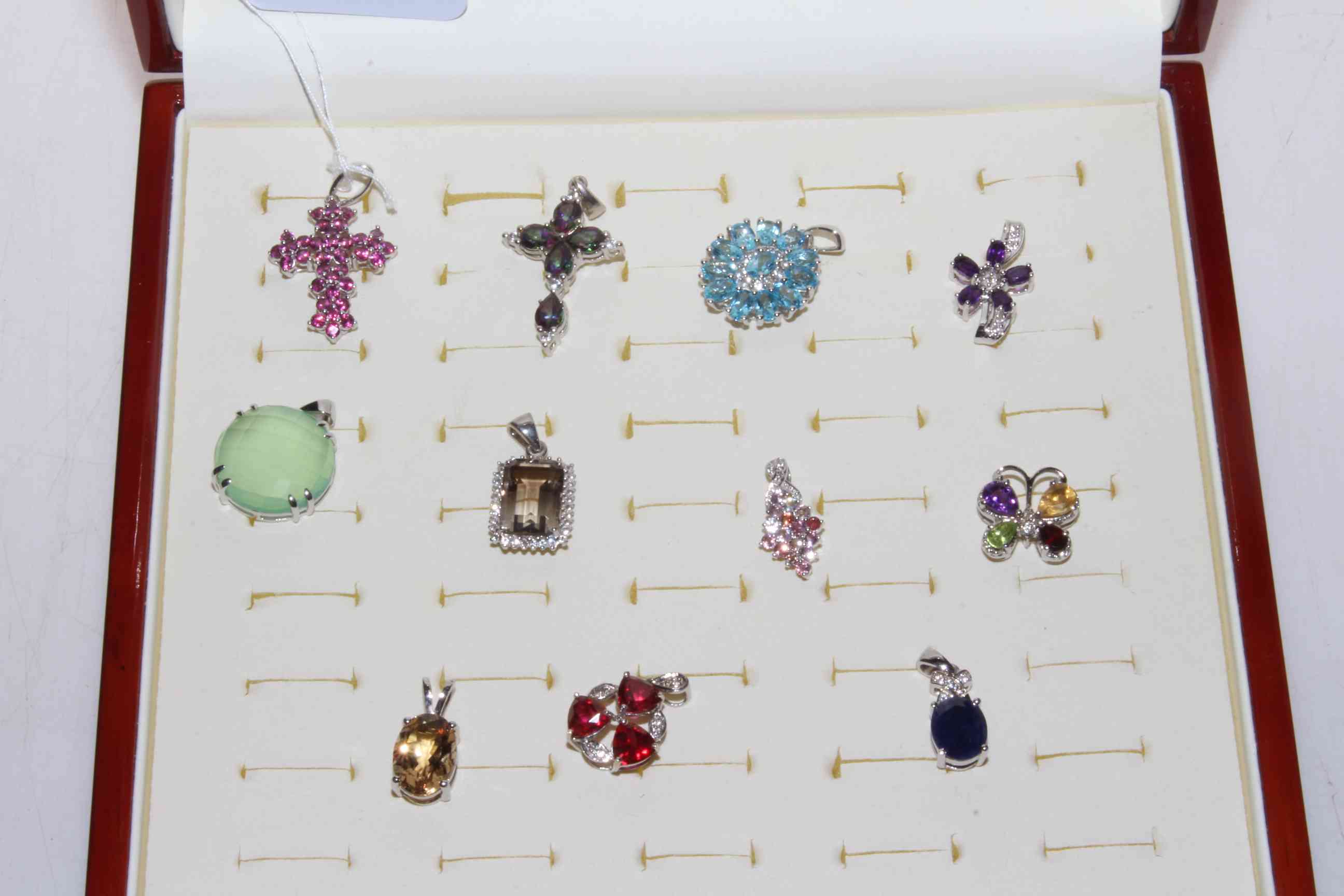 Collection of eleven silver gem set pendants.