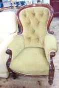 Victorian mahogany framed armchair in buttoned fabric.