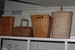 Wicker picnic basket and three wicker clothes baskets.