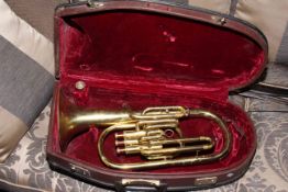 Cased French horn.