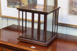 Inlaid mahogany table top revolving bookcase, 29cm high by 28cm by 28cm.