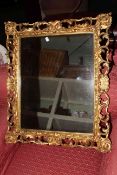 Ornate gilt wood framed wall mirror and assorted teaware.