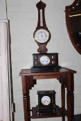 Two Victorian ornate slate mantel clocks and a barometer.