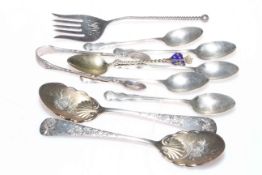 Sterling and hallmarked silver spoons, tongs, bread fork, and plated souvenir spoons.