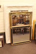 Three bevelled wall mirrors, largest 128cm by 98cm overall.