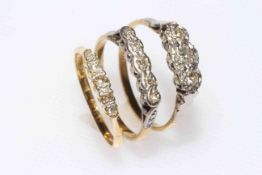 Three 18 carat gold and platinum three and five stone diamond rings.