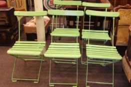 Set of five green painted folding bandstand chairs.