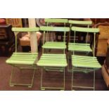 Set of five green painted folding bandstand chairs.