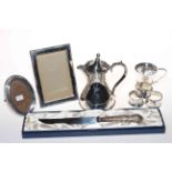 Collection of silver pieces comprising christening mug, two napkin rings and two photograph frames,