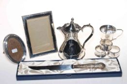 Collection of silver pieces comprising christening mug, two napkin rings and two photograph frames,