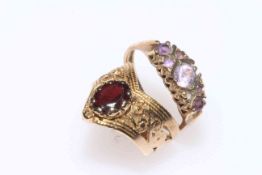 Collection of five 9 carat gold rings, one ornate with garnet.