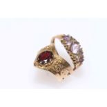 Collection of five 9 carat gold rings, one ornate with garnet.